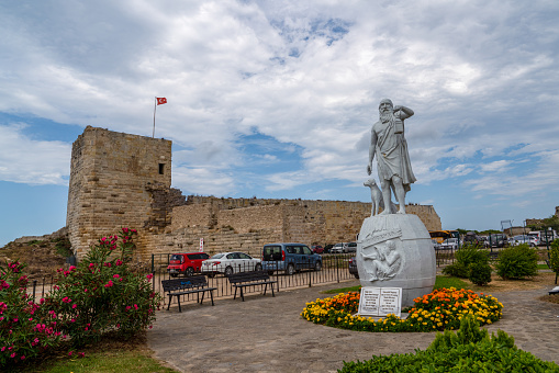Sinop/Turkey - August 04 2019: Statue Of Diogenes, famous ancient Greek philosopher born in Sinop in the 5th century BC. Sinop fortress in background.