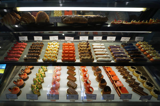 istock Assorted colorful eclair and French pastry bakery displayed in glass showcase box 1208740649