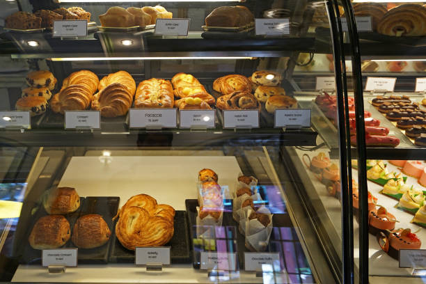 istock Assorted colorful eclair and French pastry bakery displayed in glass showcase box 1208740710