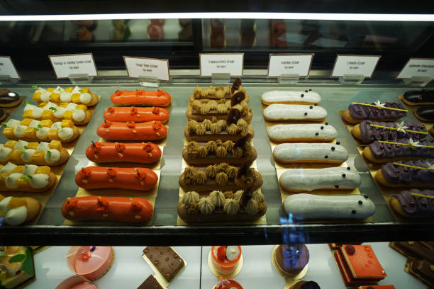 istock Assorted colorful eclair and French pastry bakery displayed in glass showcase box 1208741288