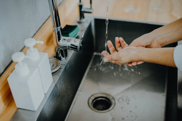 Cropped shot of a woman washing her hands thoroughly in the sink Cropped shot of a woman washing her hands thoroughly in the sink bathroom countertops stock pictures, royalty-free photos & images
