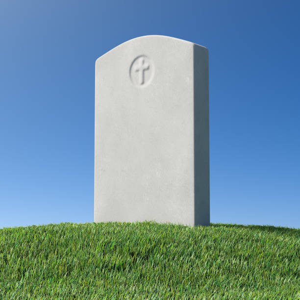 istock Gray blank gravestone on green grass hill under blue sky 1208742944