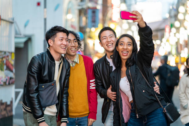 istock Group of friends taking a selfie outdoors at night 1208744942