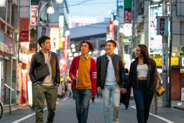 istock Group of friends outdoors at night in Tokyo 1208744961