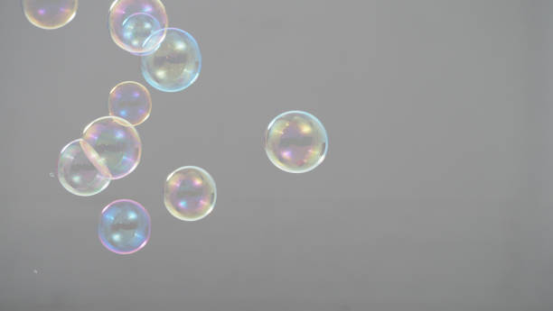 istock Real soap bubbles floating and moving on studio background which made from soapy shampoo and blow by people to represent light wind and refreshing mood 1208745066