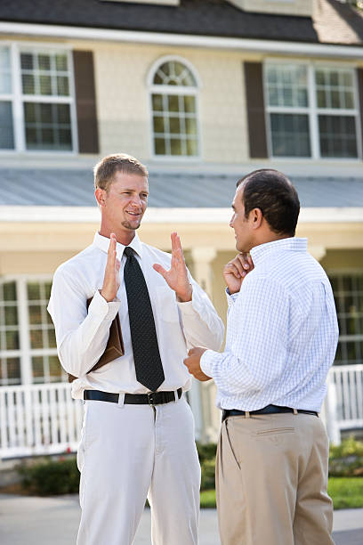 istock Two men talking in street outside house 120874658