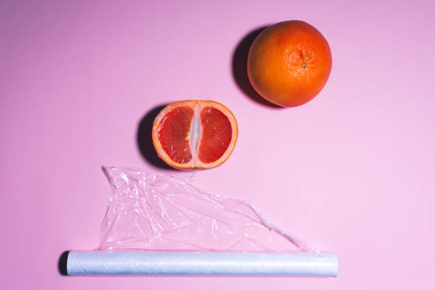 istock Roll packing with stretch film on a pink background packing fruit. place for text, top view 1208750050