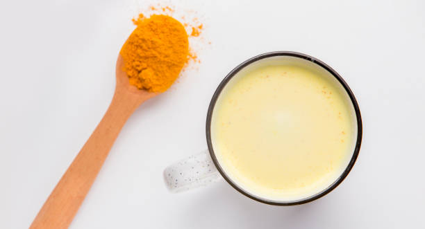 istock Turmeric powder, mandeln milk on white, panorama 1208750318
