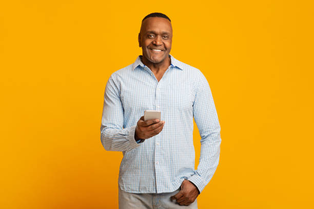 istock Mature african american man networking on cellphone 1208750744