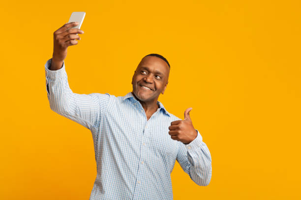 istock Modern african middle aged man making selfie 1208750782