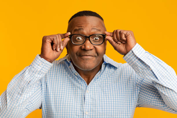 istock Middle aged afro man looking at camera through glasses 1208751138