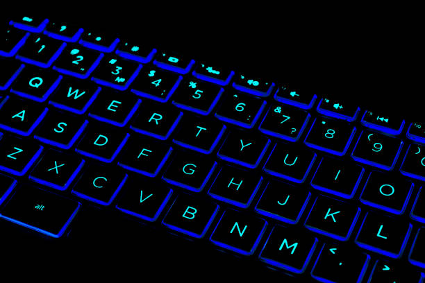 istock Close up view of a modern laptop computer keyboard keys. Soft lightning in green tones. Pc computer keyboard close up 1208751904