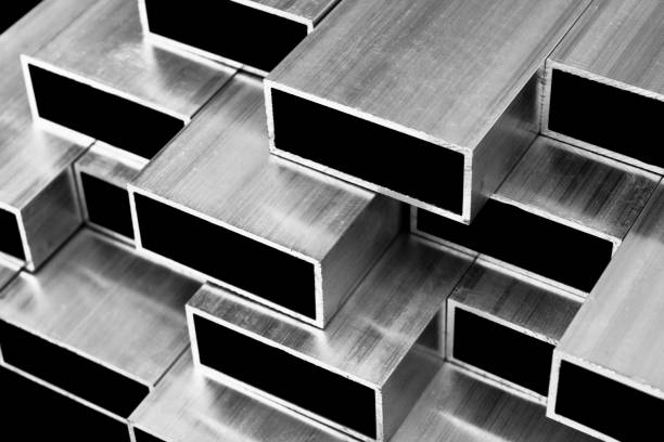 istock Aluminium profile for windows and doors manufacturing. Structural metal aluminium shapes. Aluminium profiles texture. Aluminium constructions factory background. Black and white 1208752741