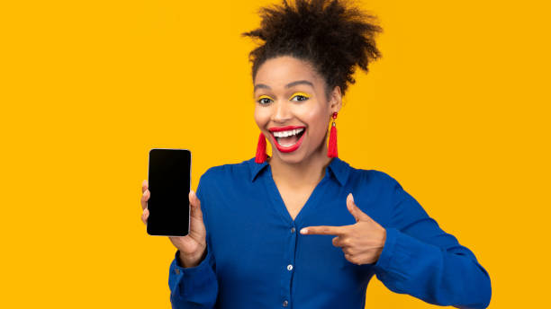 istock Black girl showing blank cell phone screen 1208753128