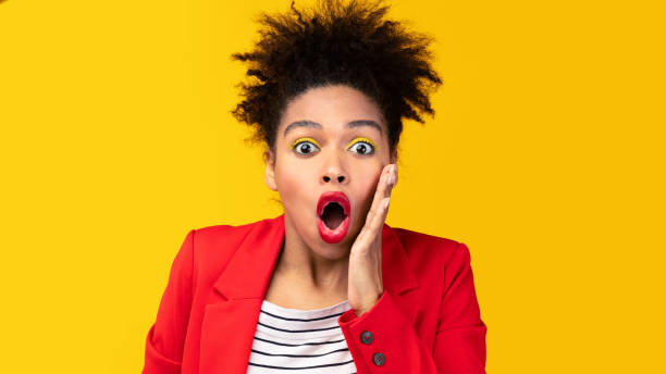 istock Surprised afro woman screaming and touching her cheek 1208753173