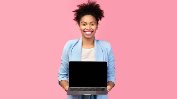 istock Happy black girl showing black blank computer screen 1208753882