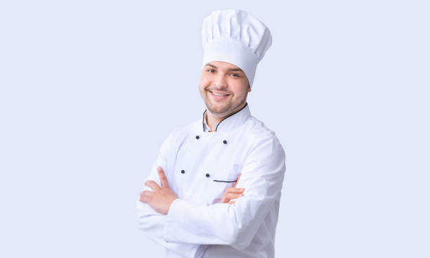 istock Male Chef Standing Crossing Hands Smiling To Camera, Studio Shot 1208754069