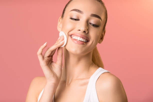istock Girl Using Cotton Pad Caring For Skin On Pink Background 1208754148