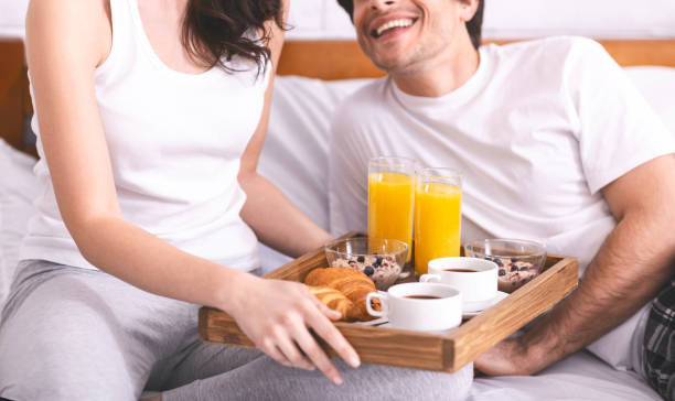 istock Young married couple enjoying breakfast in bed 1208754596