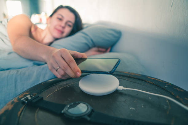 istock woman put cellphone for charging on wireless charge 1208755015