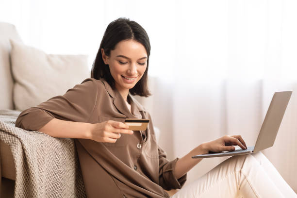 istock Young woman making purchases sitting on the floor 1208755052