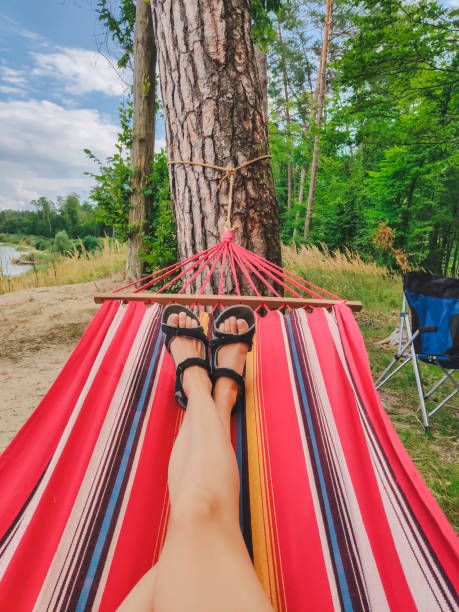 istock woman legs laying at hammock 1208755268