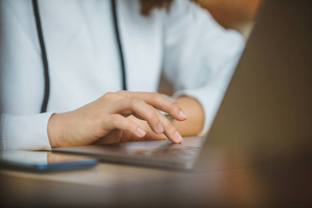 istock woman hand on laptop touchpad close up 1208755383