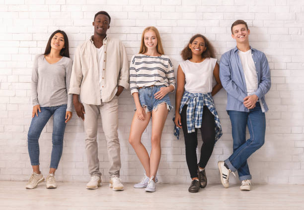 istock Group of international students hipsters posing over white wall 1208760184