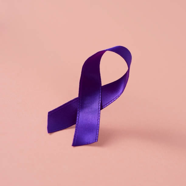 istock purple ribbon on a pink background 1208761337