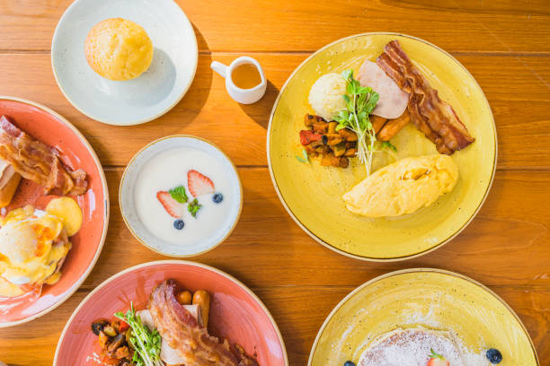 istock Fried egg with eggs benedict and omelette around bacaon ham sausage in plate 1208762006