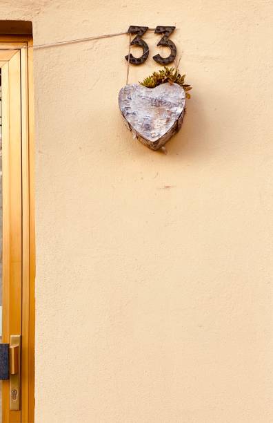 istock House number 33 with heart shaped flower pot 1208763538