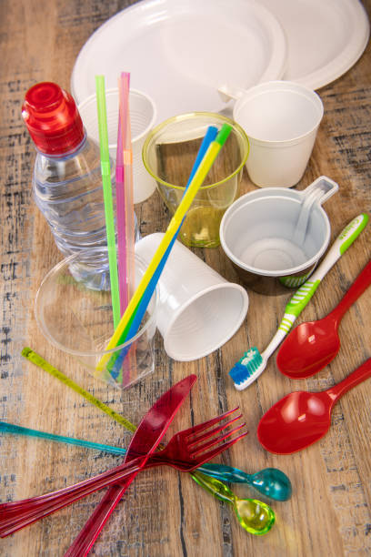 istock Everyday plastic waste, various plastic utensils, environmental protection on wood background 1208764882