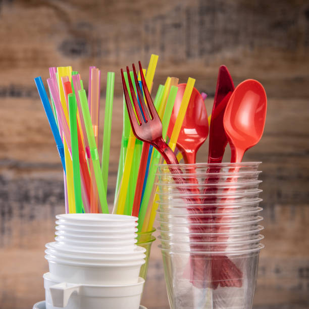 istock Everyday plastic waste, various plastic utensils, environmental protection on wood background 1208764955