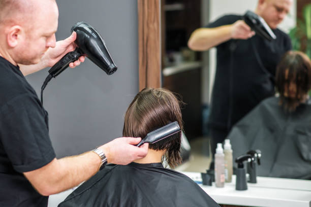 istock Hairstylist dries woman's hair. 1208765553