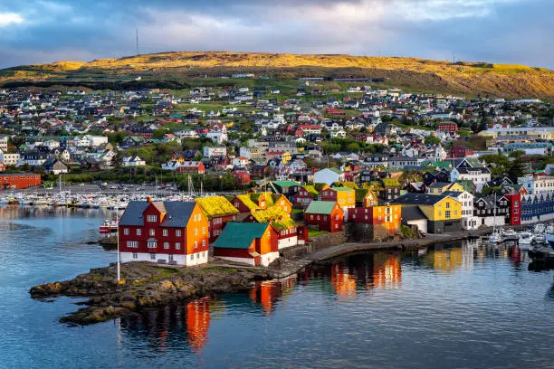Sunrise scene of capital city Torshavn in Faroe Islands in North Atlantic. Urban scene of scandinavian city in warm golden sunlight.