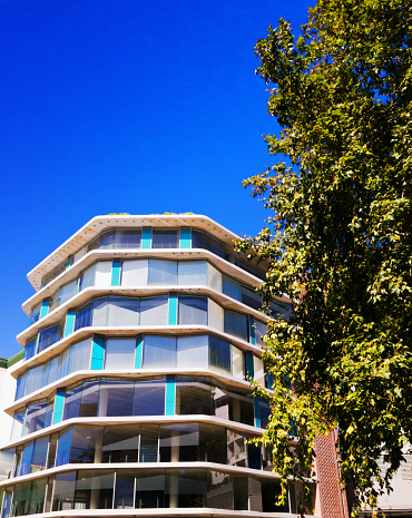 The exterior of a modern building with many angles. It could be an office block, apartments, or a hotel.