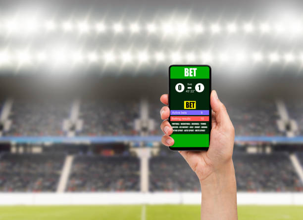 istock man using a mobile phone shows a betting application with live results and updates 1208766699