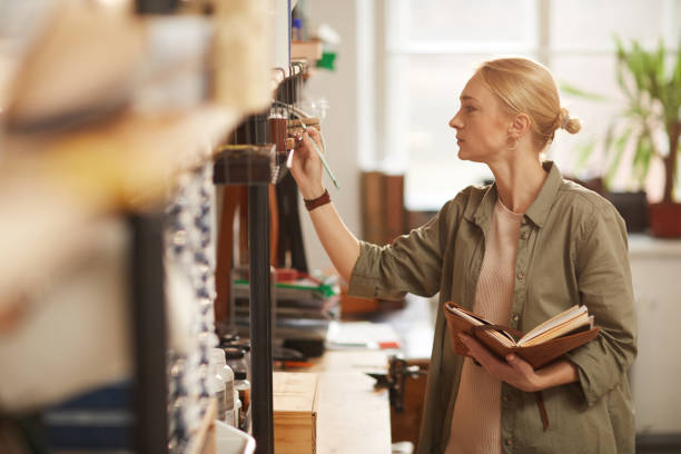 istock Woman Checking Availability Of Materials 1208767644