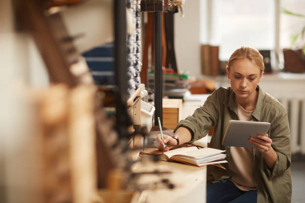 istock Young Woman Doing Calculations 1208767702