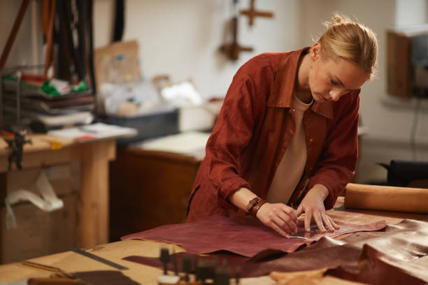 istock Young Craftswoman Cutting Out Leather 1208767951