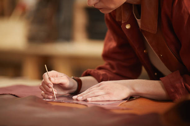 istock Woman Cutting Out Leather 1208768025