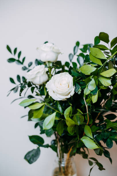 istock Floral composition in interior. Bunch with white roses and green leaves. 1208771038