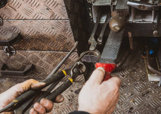 istock Construction details of male worker or handy man with power tools. Technology and handy work concept. Power tools and hands of construction worker. Focus on the tools. Warm desaturated filter. 1208771650
