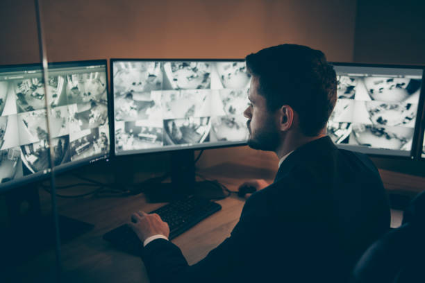 istock Profile side view portrait of his he nice attractive serious focused professional guy providing remote safe safety service supervising tv panel at workplace workstation indoors 1208773033