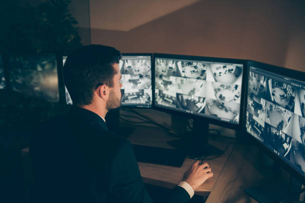 istock Profile side view portrait of nice serious web specialist supervising alarm panel night shift calling online information technical support 24.7 bank safety management at workplace workstation 1208773171