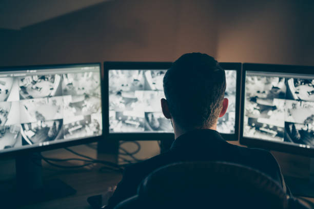 istock Rear back behind view of his he professional expert supervising remote panel using safety system technology equipment night shift company safety support at workplace workstation 1208773201