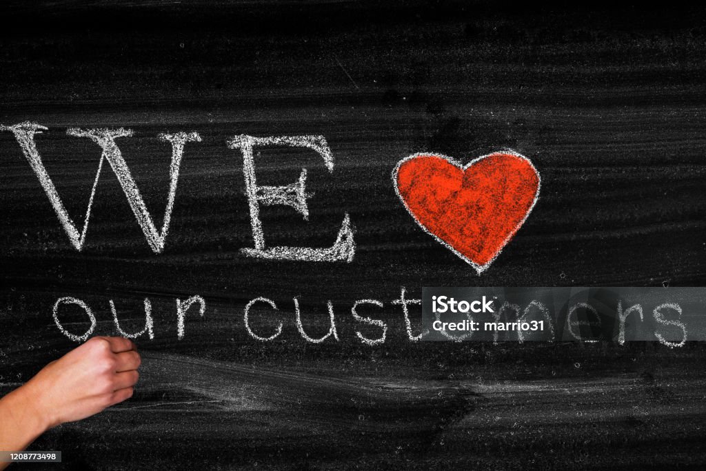 We love our customers We love our customers,business concept on blackboard Service Stock Photo