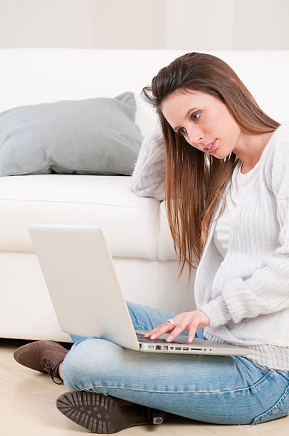 istock Absorbed young woman working on laptop 120877358