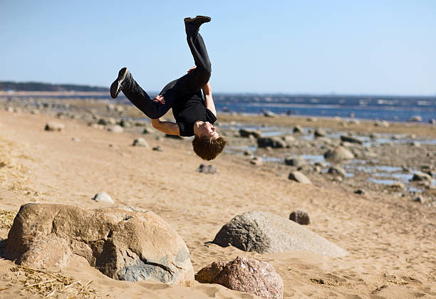 istock Young man makes extreme jump-overturn over stones. 120877602