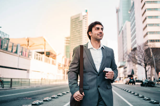 istock Happy businessman with a coffe on the city 1208777074